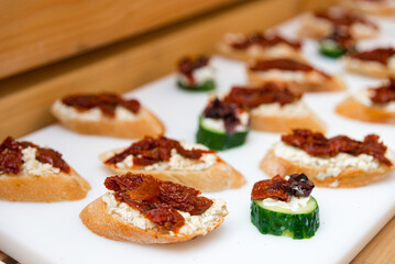 tapas appetizer with salmon and cream cheese, tapas with sun-dried tomatoes