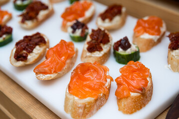 tapas appetizer with salmon and cream cheese, tapas with sun-dried tomatoes