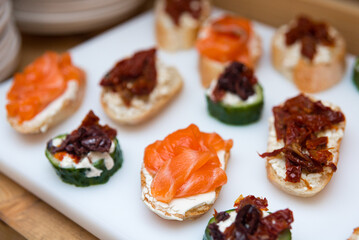 tapas appetizer with salmon and cream cheese, tapas with sun-dried tomatoes