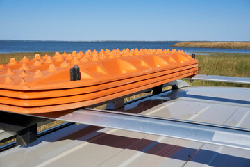 Recovery traction boards, ladders or track mounted on the roof rack of a Four Wheel Drive