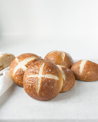 Pretzel buns on a marble tray, German laugenbroetchen, lye buns on a marble tray