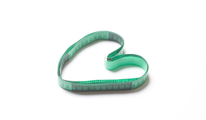 a measuring tape in the shape of a heart on a white background, with copy space for your text stock...