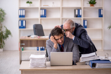 Two male colleagues working in the office