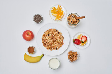 some food on a plate with bananas, apples, oranges, and yories next to each other bowls