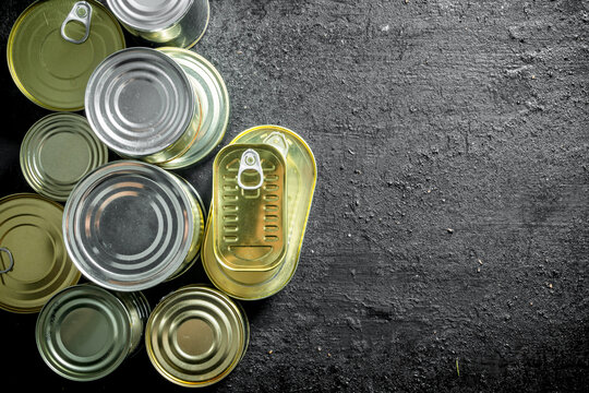 Set of different kinds of tin cans with canned food.