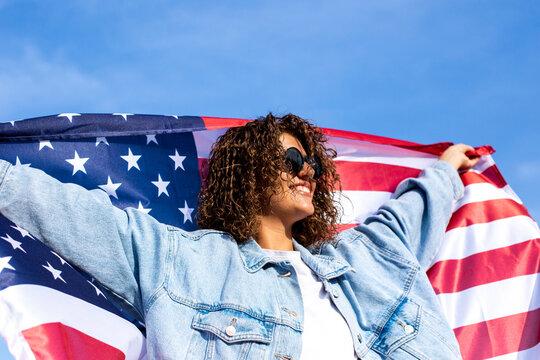 Slim beautiful woman holding USA flag
