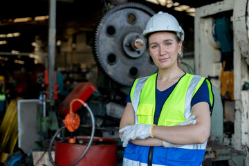 Portrait of woman engineer wear white helmet arms crossed in uniform standing at industrial...