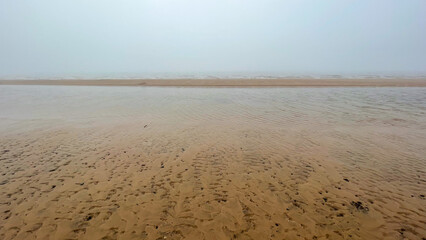 beautiful sandy seashore in fog