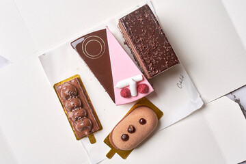different types of chocolates on a piece of paper next to an image of a teddy bear and other items