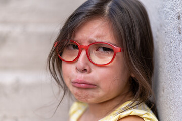 Girl with a sobbing face on the verge of tears.