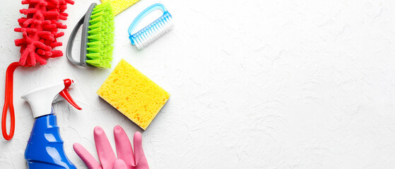 Different cleaning supplies on white background with space for text, flat lay