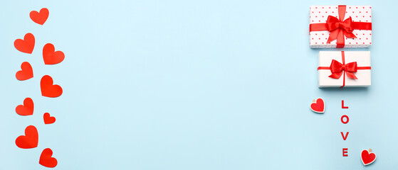 Gift boxes and hearts on light blue background with space for text. Valentine's Day celebration
