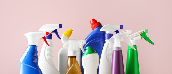 Many bottles of detergents on pink background