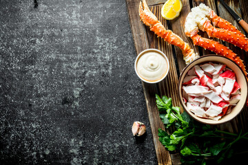 Crab meat and fresh crab on tray with sauce, lemon slices and parsley.