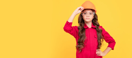 Builder teenager girl in helmet. happy kid girl in safety glasses and helmet, worker. Child builder in helmet horizontal poster design. Banner header, copy space.