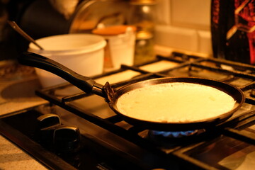 cooking pancake at home on the stove in a frying pan. Pancake week
