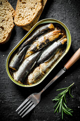 Sprats in a tin with sliced bread.
