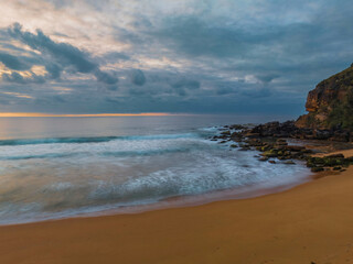 Soft sunrise seascape with clouds and colour on the horizon