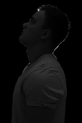 Silhouette of young man on black background