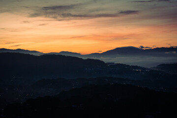 Fototapeta na wymiar Sunrise in the mountains over the clouds