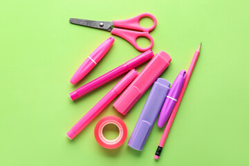 Set of stationery with scissors on green background