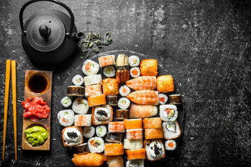 Set a variety of rolls, sushi and maki with green tea.