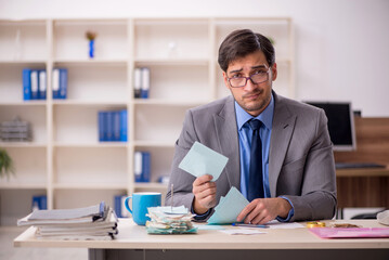 Young male accountant working in the office