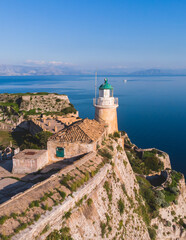 Fototapeta na wymiar Aerial panoramic drone view of Old Venetian Fortress of Corfu, Palaio Frourio, Kerkyra old town, Greece, Ionian sea islands, with the lighthouse, church and scenery beyond the city, summer sunny day