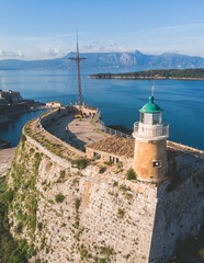 Fototapeta na wymiar Aerial panoramic drone view of Old Venetian Fortress of Corfu, Palaio Frourio, Kerkyra old town, Greece, Ionian sea islands, with the lighthouse, church and scenery beyond the city, summer sunny day
