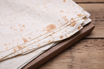 Delicious Armenian lavash on wooden table, closeup