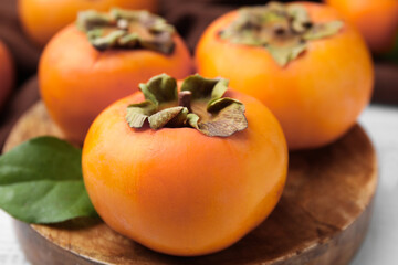Delicious ripe juicy persimmons on table, closeup