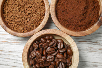 Instant, ground coffee and roasted beans on white wooden table, flat lay