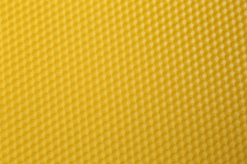 Natural beeswax sheet as background, top view