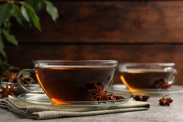 Aromatic tea with anise stars on light grey table. Space for text