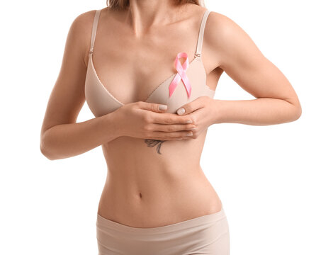 Young woman in underwear with pink ribbon on white background. Breast cancer awareness concept