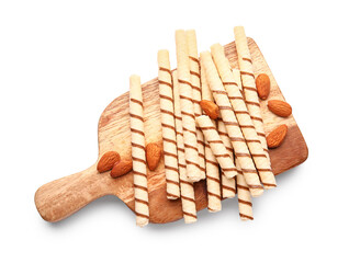 Cutting board with tasty wafer rolls and almonds isolated on white background