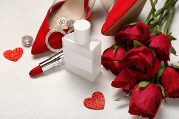 Perfume, lipstick, jewelry, heels and roses for Valentine's day on white background, closeup