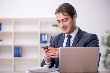 Young male employee working in the office