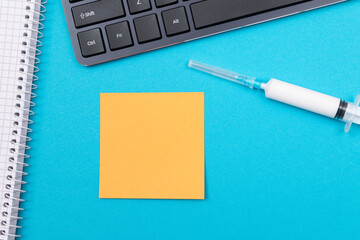 Vaccination, Immunology or Revaccination Concept - A Medical Disposable Syringe Lying on Blue Table...