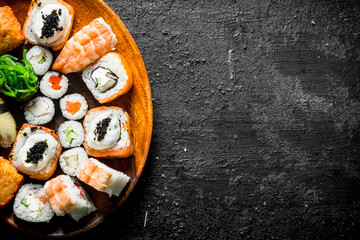 Different kinds of sushi rolls on the plate.