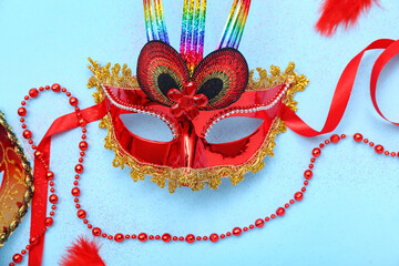 Carnival mask with beads on blue background