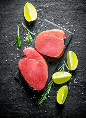 Fresh raw tuna steak with lime and rosemary.