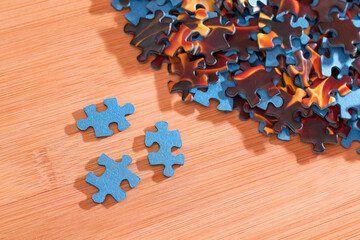 Colorful Peaces of a Mixed Jigsaw Puzzle Lie on the Wooden Table - Strategy and Solving Problem Concept