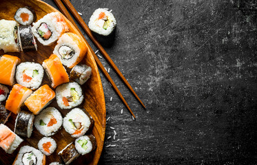 Various rolls on a wooden plate.