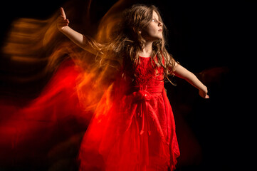 Naklejka premium Portrait of a cute little girl dancing