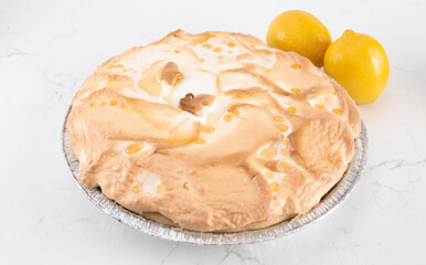Whole Fresh Lemon Meringue Pie on a Kitchen Counter