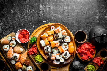 Obraz na płótnie Canvas Set traditional Japanese sushi rolls on cutting boards.