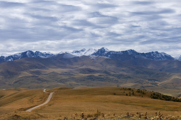 Fototapeta na wymiar A winding mountain road to the Djily Su tract with beautiful views of the Elbrus peaks.