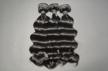 loose wavy black color human hair weaves extensions bundles on black background