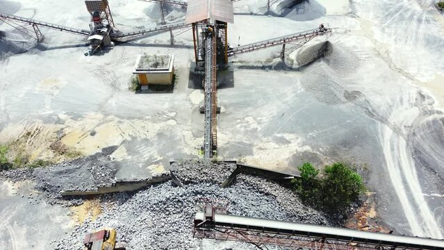 Stone crushing machine system at open pit mining quarry. Aerial drone shot
